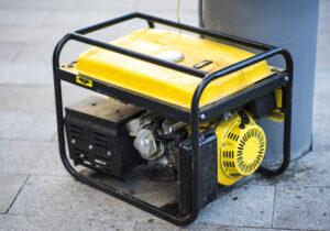 Gasoline Portable Generator On The House Construction Site. Close Up On Mobile Backup Generator .standby Generator Outdoor Power Equipment
