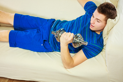 Young Man Fit Body Relaxing On Couch After Training
